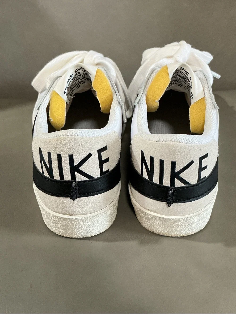 Nike White Low-Top Sneakers with Black Swoosh and Neon Yellow Accents